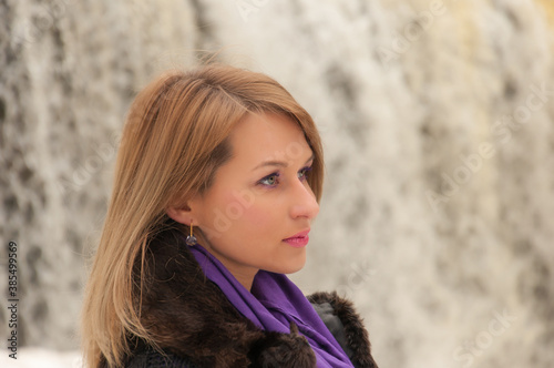 woman portrait on a waterfall background © Yury