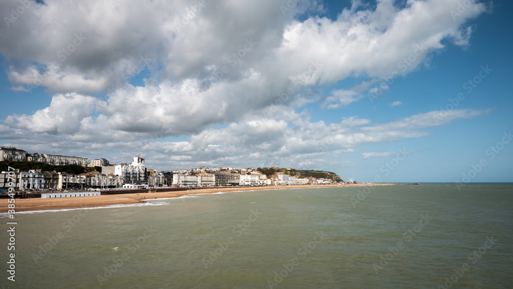 Hastings, East Sussex, England. The seafront to the seaside town on the British south coast with its landmark castle visible on top of the hill.