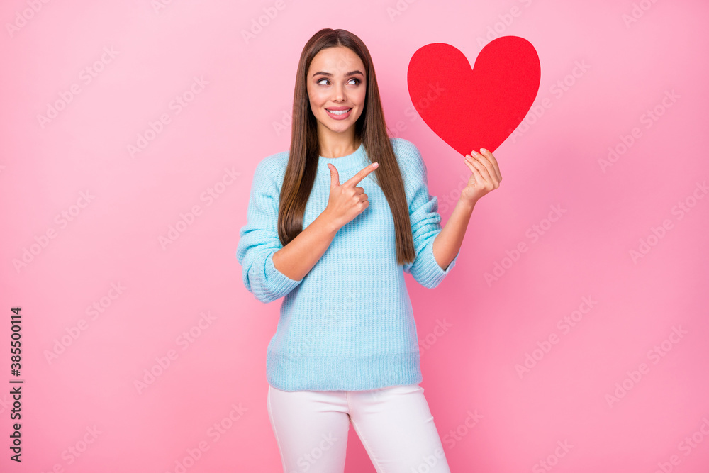 Photo of pretty lady hold big paper red heart direct finger creative postcard idea lovers greeting cards wear knitted blue sweater white trousers isolated pastel pink color background Photo of pretty lady hold big paper red heart direct finger creative postcard idea lovers greeting cards wear knitted blue sweater white trousers isolated pastel pink color background