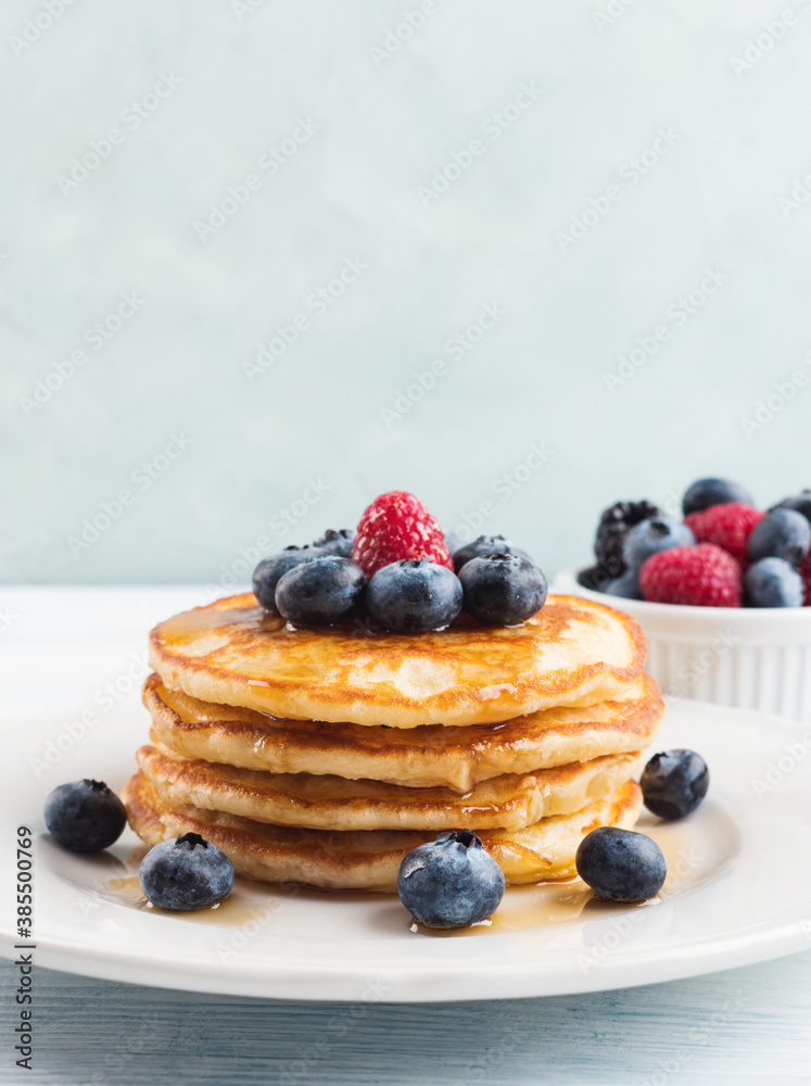 Stack of pancakes with fresh blueberries served in a dish with maple syrup. Delicious breakfast Stack of pancakes with fresh blueberries served in a dish with maple syrup. Delicious breakfast