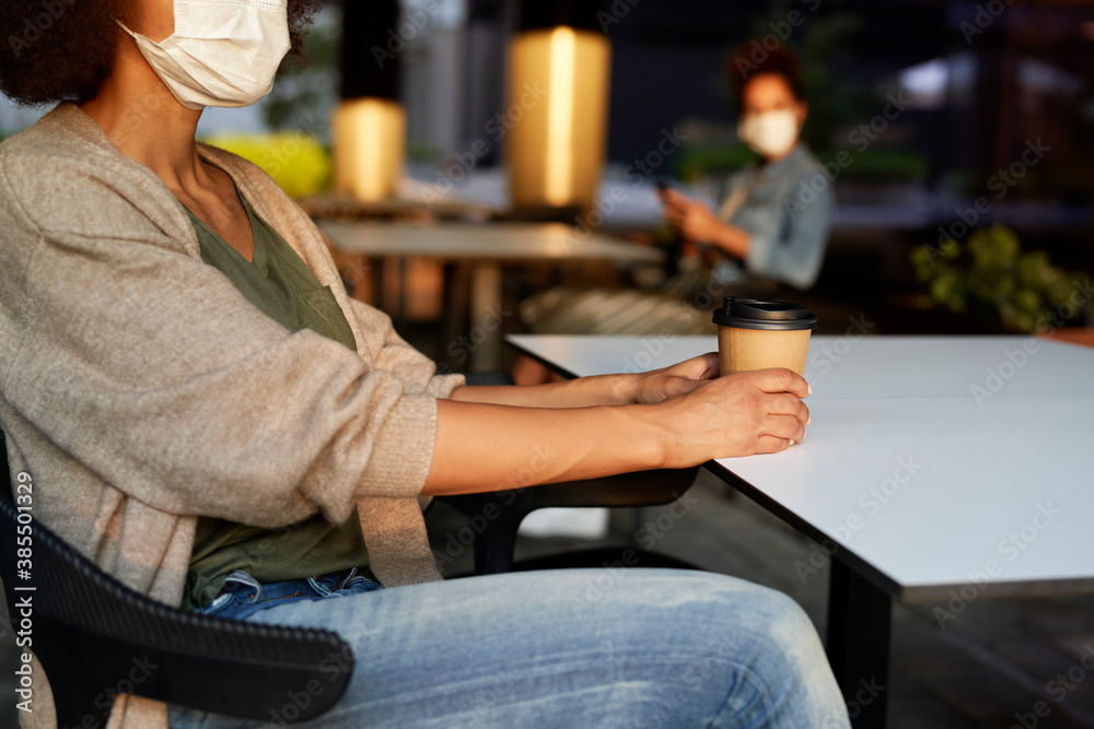 Woman in face mask drinking take away coffee Woman in face mask drinking take away coffee