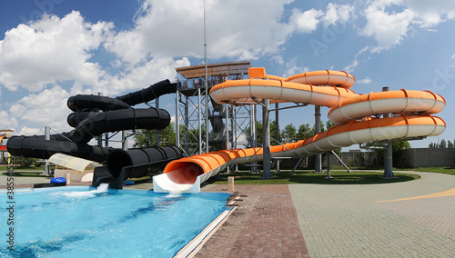 Outdoor water park. Multi-colored slides and pools.
