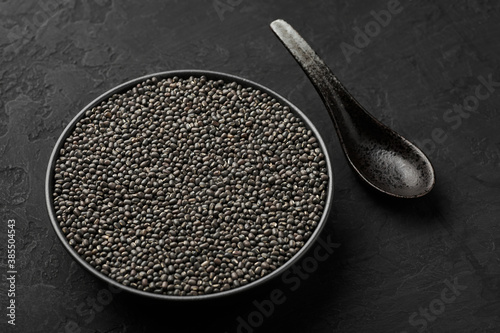 Black Gram or Urad Beans or Mung Beans in bowl on dark slate table top. Vigna Mungo is popular indian cuisine food ingredient.