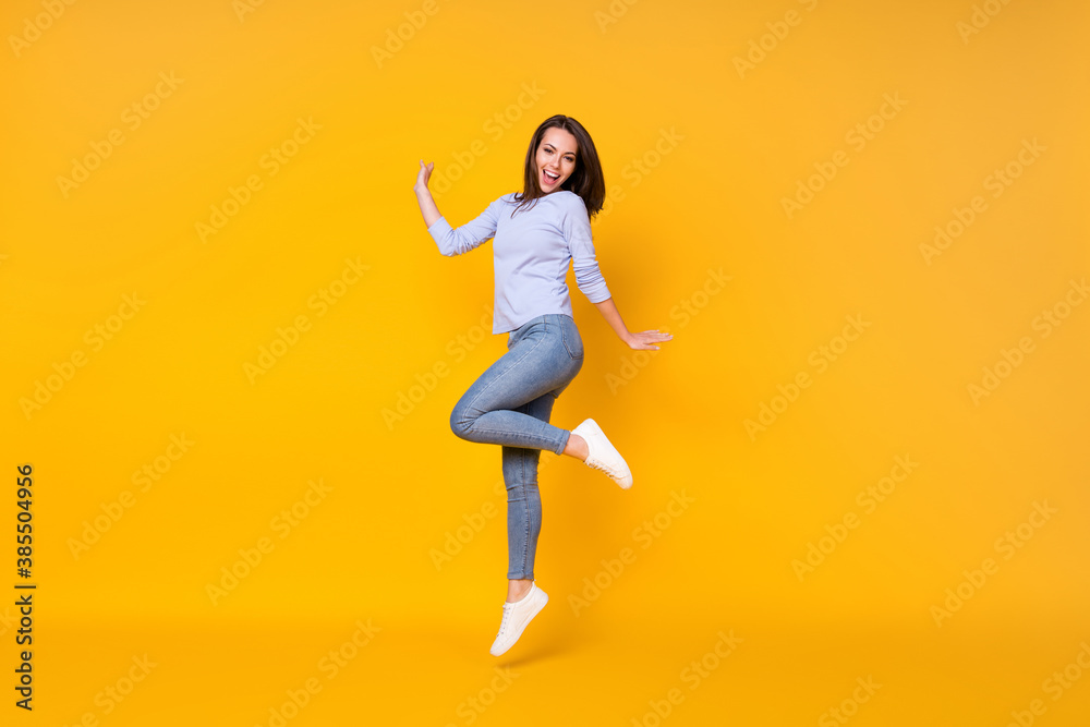 Full length body size view of her she attractive pretty lovely cheerful cheery girl jumping having fun good mood healthy comfort life isolated bright vivid shine vibrant yellow color background