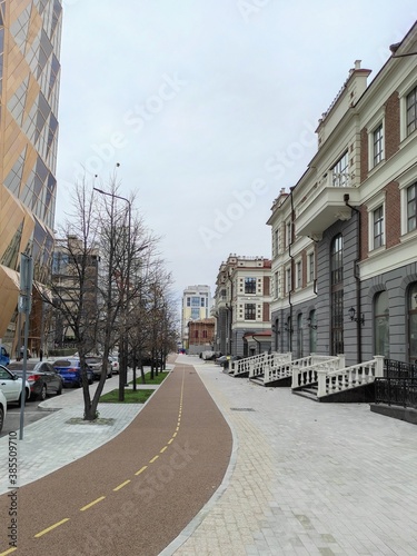 The bicycle path in downtown Yekaterinburg, Russia. Painted lane dividers for better flow, and rider control. Detail of the sidewalk and bike path of the city.