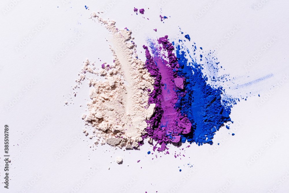 Fototapeta premium top view of purple, blue and white eyeshadow powder