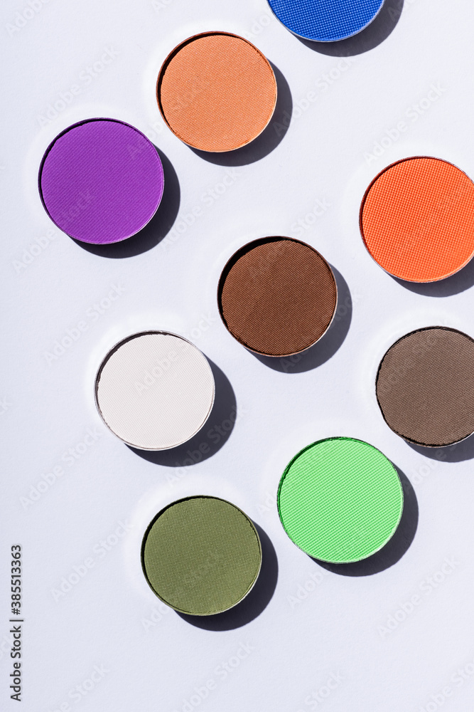 top view of multicolored eyeshadow on white background top view of multicolored eyeshadow on white background