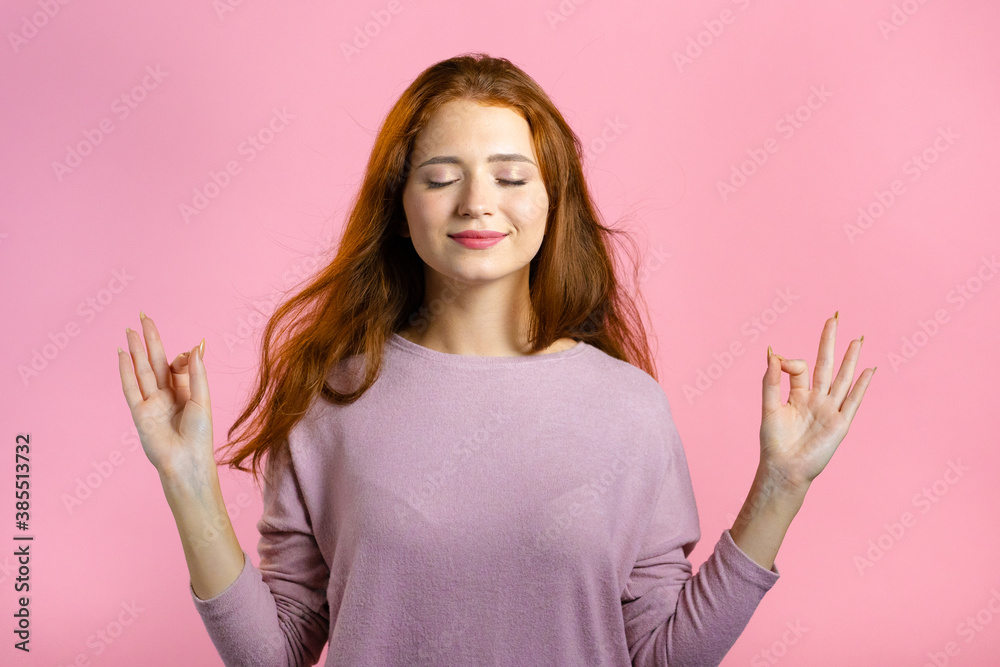 Calm woman relaxing, meditating. Girl calms down, breathes deeply with mudra om on pink studio background Calm woman relaxing, meditating. Girl calms down, breathes deeply with mudra om on pink studio background