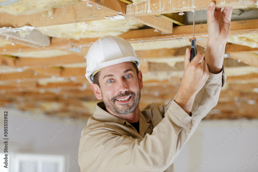portrait of tradesman using a screwdriver portrait of tradesman using a screwdriver