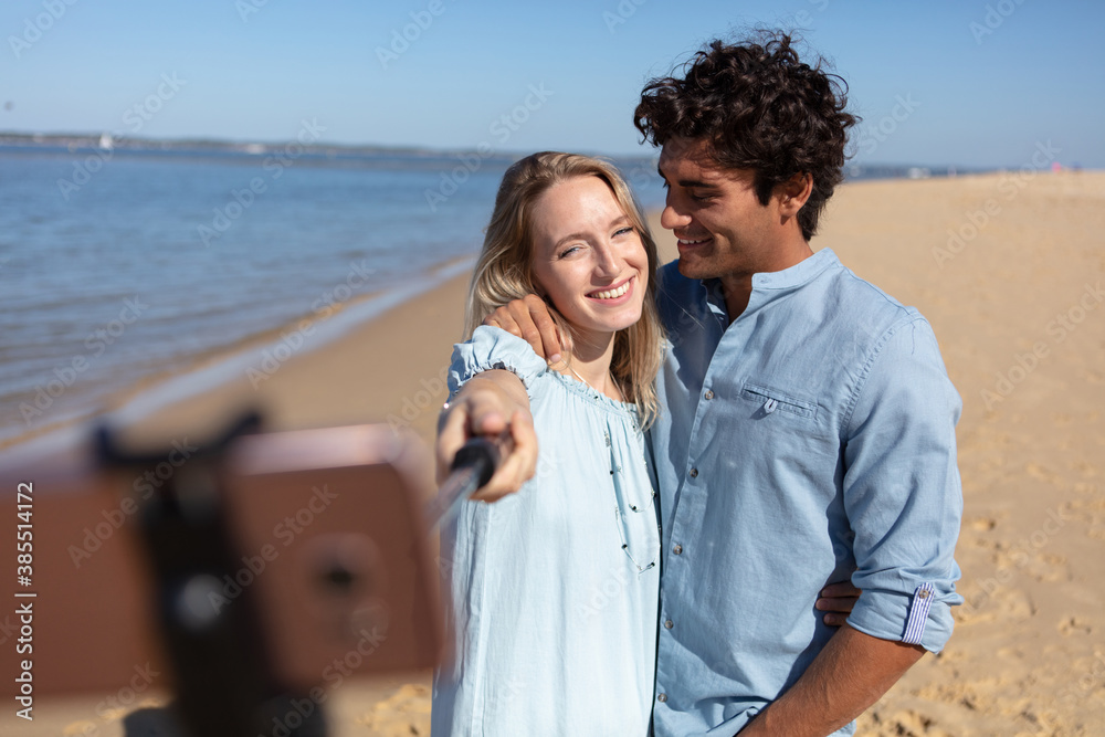 couple taking a selfie on the beach