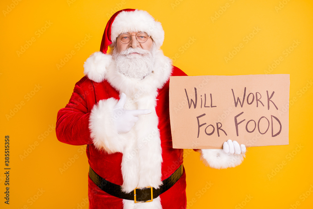 Portrait of his he nice jobless fired serious white-haired Santa holding in hands demonstrating paper card promo will work for food isolated bright vivid shine vibrant yellow color background Portrait of his he nice jobless fired serious white-haired Santa holding in hands demonstrating paper card promo will work for food isolated bright vivid shine vibrant yellow color background