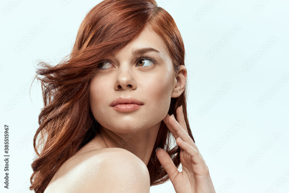 Pretty woman holding hair smile cosmetics lifestyle naked shoulders hairstyle care charm light background Pretty woman holding hair smile cosmetics lifestyle naked shoulders hairstyle care charm light background