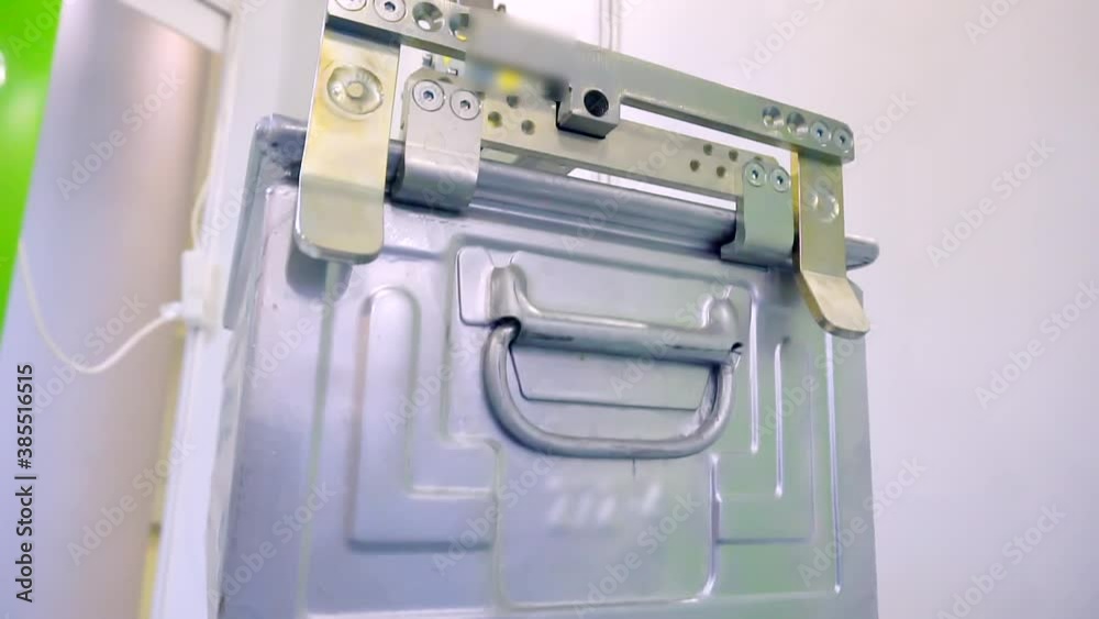 mechanical manipulator of an industrial robot neatly moves the box. close-up. mechanical manipulator of an industrial robot neatly moves the box. close-up.