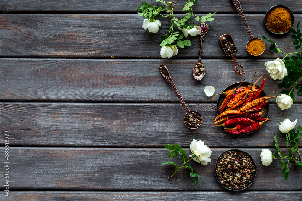 Set of spices and herbs for cooking in metal spoons and bowls, top view Set of spices and herbs for cooking in metal spoons and bowls, top view