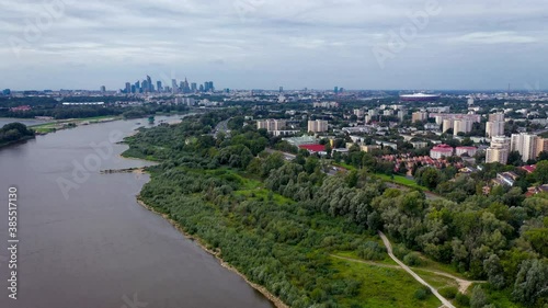 4k drone footage of Vistula River bank in Praga Poludnie district of Warsaw city, Poland - city downtown on background photo