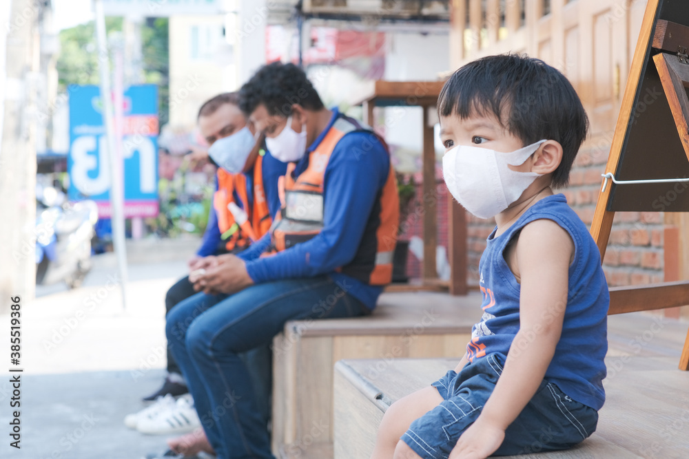 Little boy wear mask sitting in cafe restaurant social distancing Little boy wear mask sitting in cafe restaurant social distancing