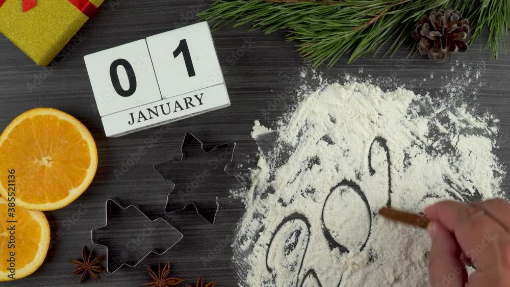 preparing festive treats for Christmas and new year holidays. calendar with the date January 01. bull as a symbol of the new year 2021. flat layout. cookie molds and flour. orange and star anise. 