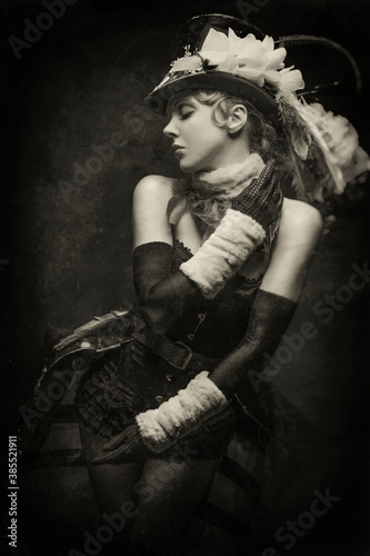 Old-fashioned black and white portrait of a young cabaret showgirl in her stage costume photo