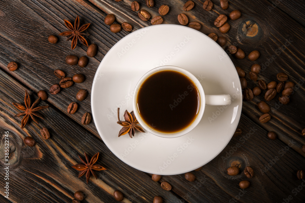 White cup of coffee on a wooden background White cup of coffee on a wooden background