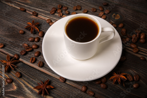 White cup of coffee on a wooden background