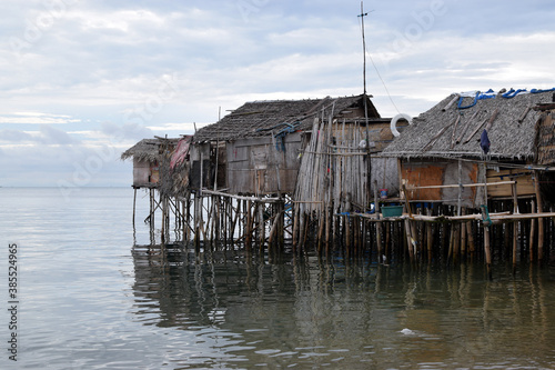 Bamboo poles support the stilt Bajau shanty houses built by indigenous people in the philippines. lmedium long shot photo