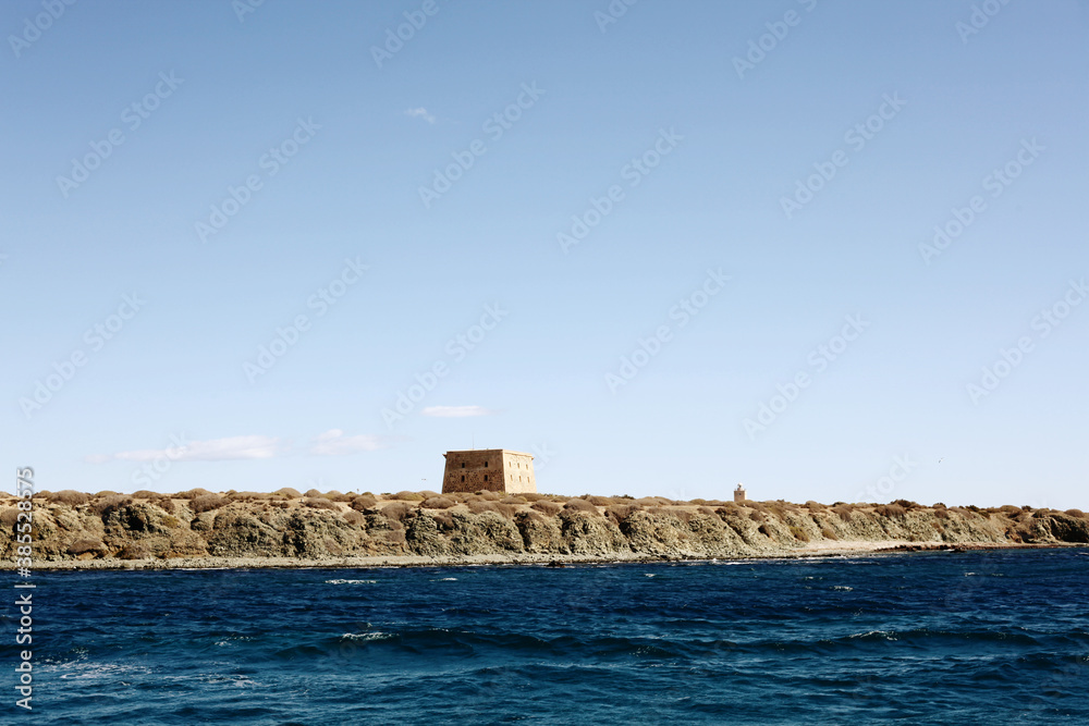 Mediterranean sea and in the horizon Tabarca island. Clear sky. Alicante, Spain. Text of text.