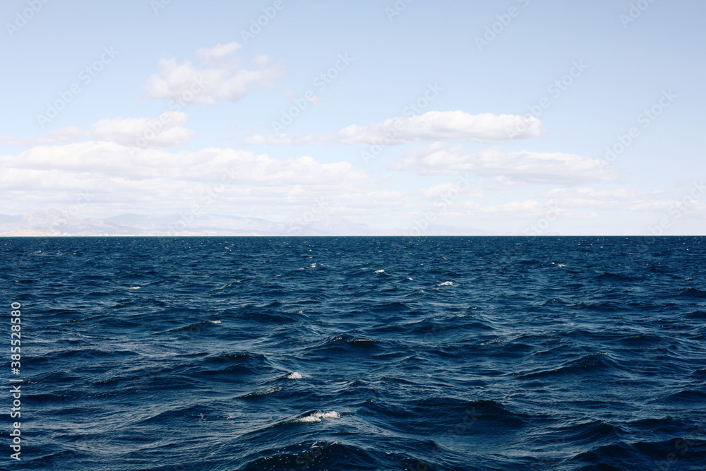 Mediterranean blue, calm sea and horizon, clear sky in Alicante, Spain. Space for text. Mediterranean blue, calm sea and horizon, clear sky in Alicante, Spain. Space for text.