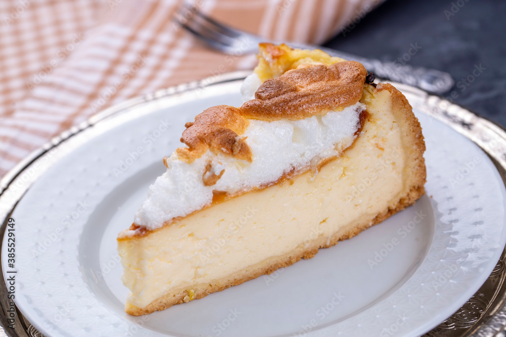Homemade german cheesecake on beautiful plate on white table. Homemade german cheesecake on beautiful plate on white table.