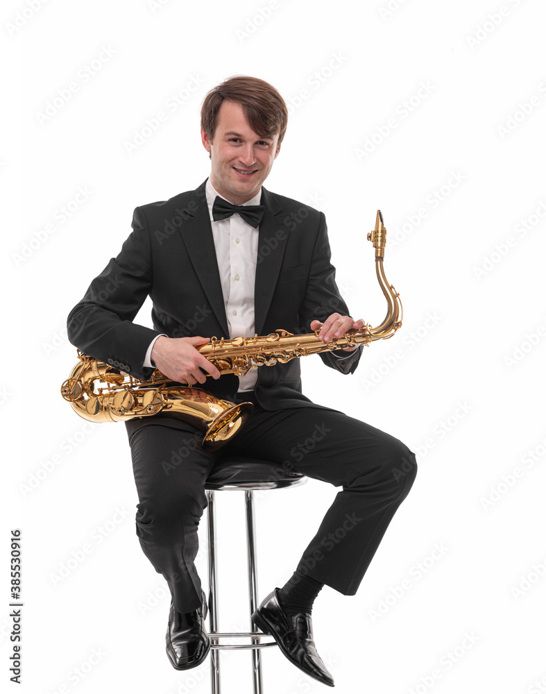 Naklejka premium Saxophonist with a saxophone in his hands on a white background.
