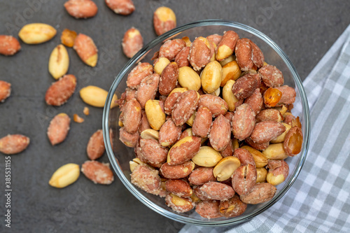 Salted peanuts in a glass bowl