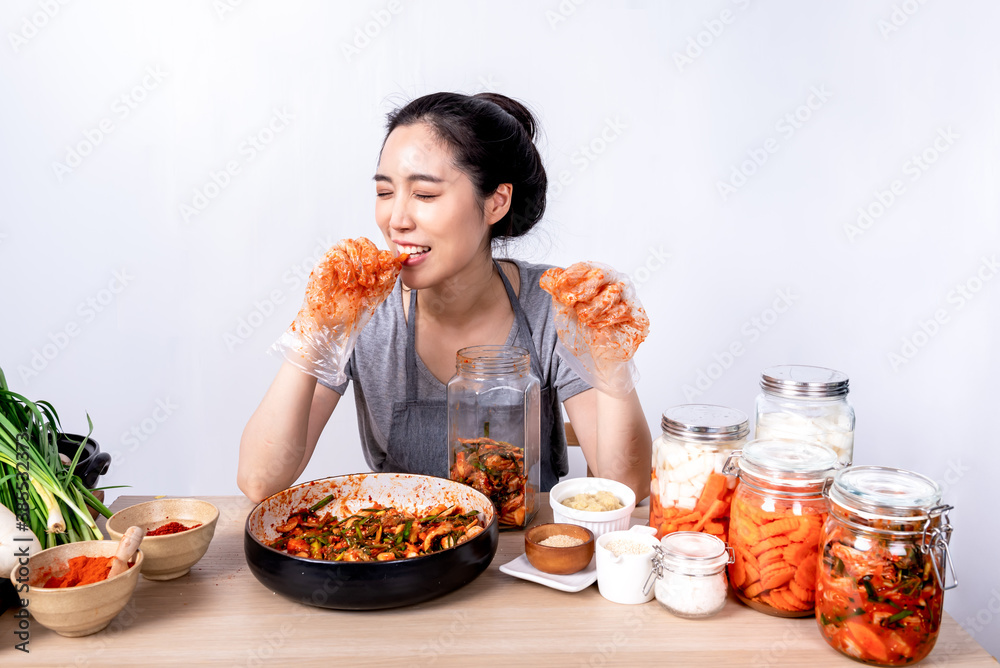 Portrait images of Korean attractive woman is eating Kimchi which she making, Kimchi which is a
