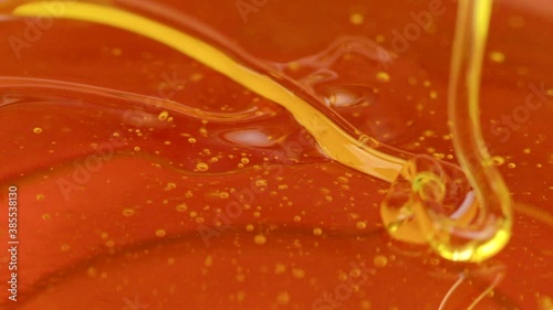 melted pine resin or amber color transparent dense viscous liquid fluid flows in beautiful flow slow motion. Advertising intro for Manufacture of adhesives, sealants, natural wood resin products