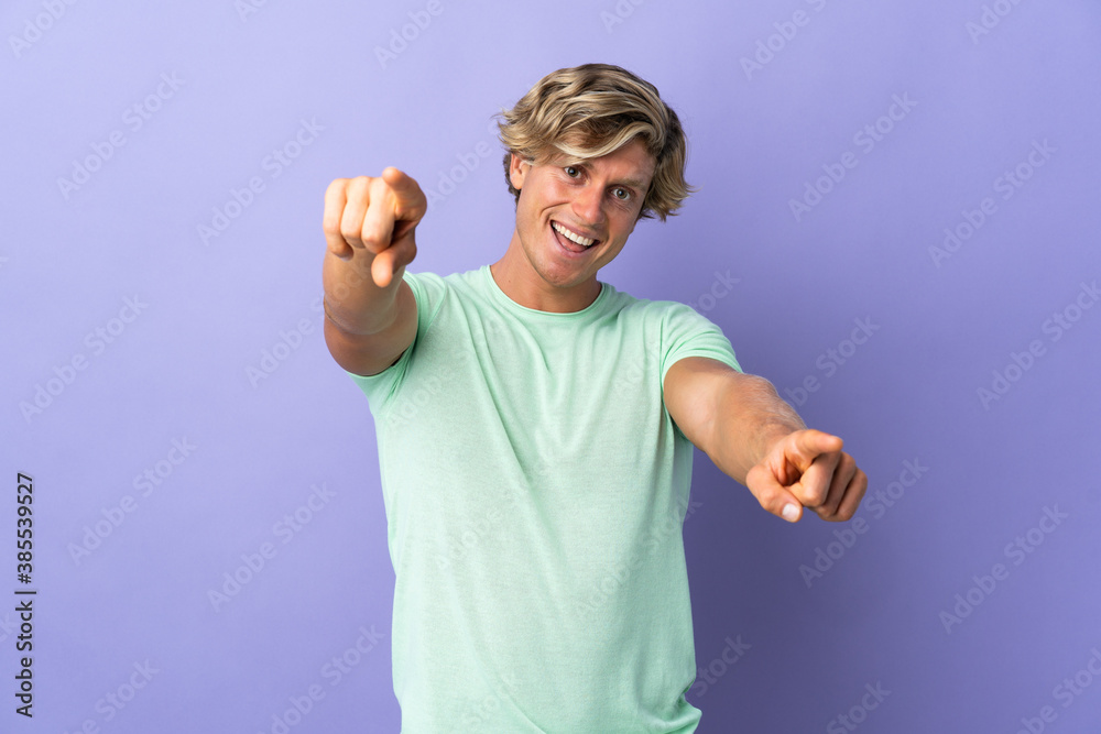 English man over isolated purple background pointing front with happy expression English man over isolated purple background pointing front with happy expression