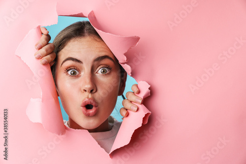 Caucasian young excited woman wondering and looking at copyspace photo