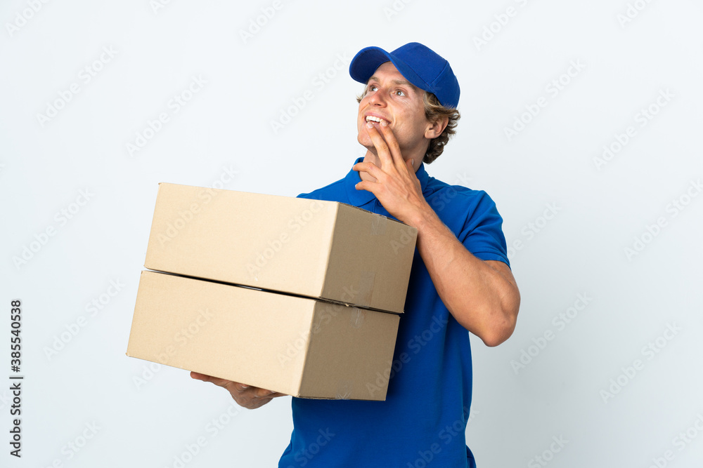 Delivery man over isolated white background looking up while smiling Delivery man over isolated white background looking up while smiling