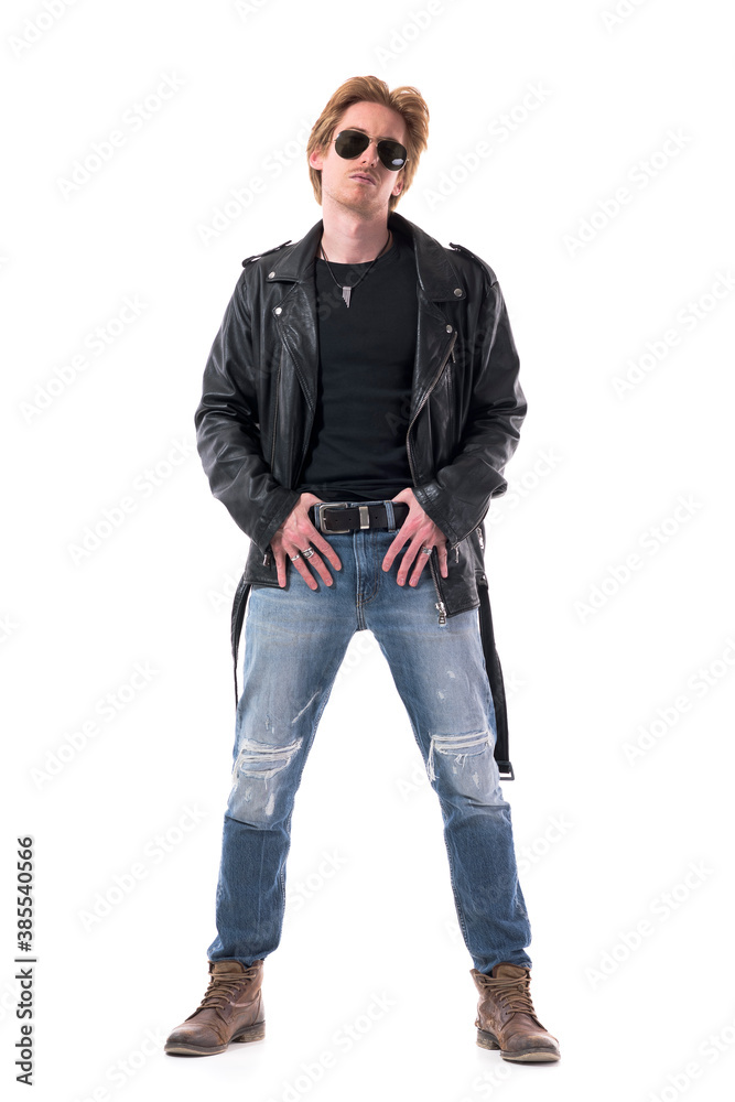 Cool attitude masculine confident rocker man in leather jacket posing with thumbs in belt. Full body isolated on white background. Cool attitude masculine confident rocker man in leather jacket posing with thumbs in belt. Full body isolated on white background.