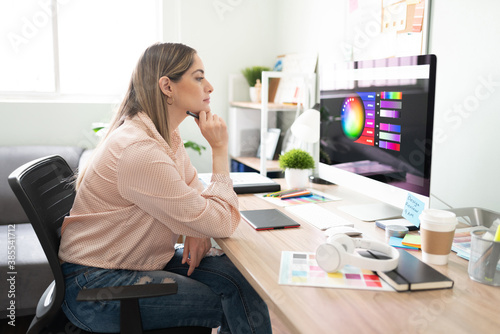 Thoughtful designer looking at her screen