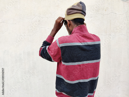 Back view of South Indian young man wearing winter hat . Isolated on white background. winter portrait © chaundthar