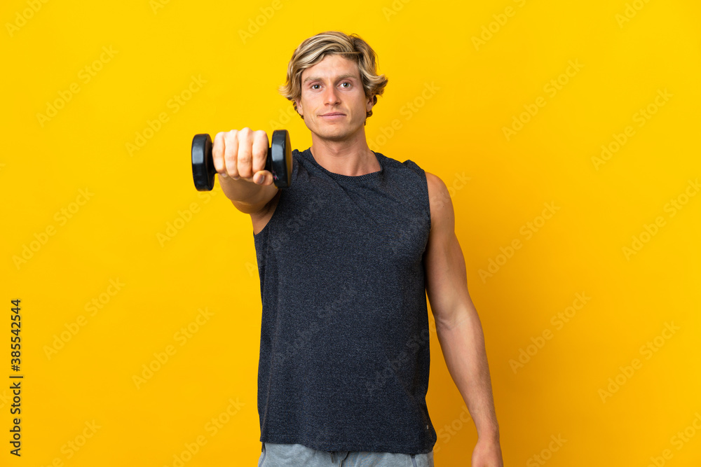 English man over isolated yellow background making weightlifting English man over isolated yellow background making weightlifting