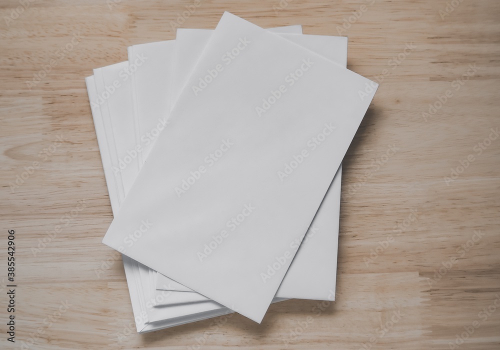 Top view of blank business cards isolated on wood background. Poster mock-ups paper, white paper Blank portrait A4. brochure magazine isolated, use banners products business cards to showcase your Top view of blank business cards isolated on wood background. Poster mock-ups paper, white paper Blank portrait A4. brochure magazine isolated, use banners products business cards to showcase your