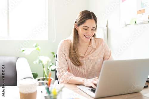 Businesswoman looking happy using a laptop photo