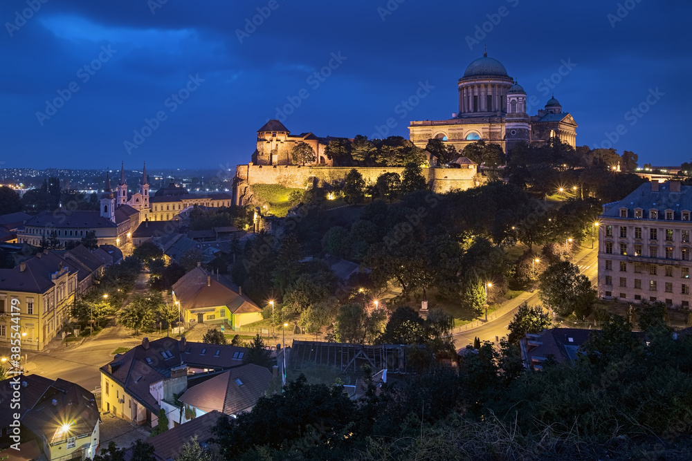 Esztergom, Hungary. Evening view of Esztergom Basilica on the top of hill, and Parish Church of St. Ignatius of Loyola and Convent Church of the Exaltation of the Holy Cross at the foot of hill. 