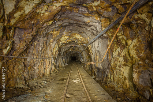 Underground gold ore mine tunnel with rails