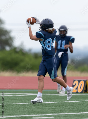 Amazing athletes making great catches and runs during a competitive football game