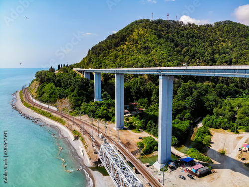 Distant view of modern bridge road in summer mountains