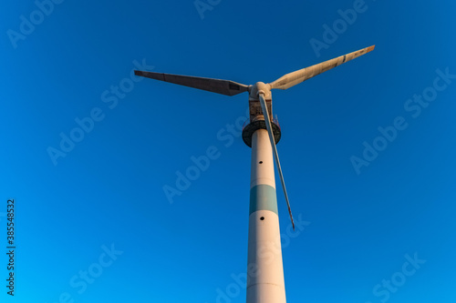 Close up of old abandoned wind turbine and the blue sky photo