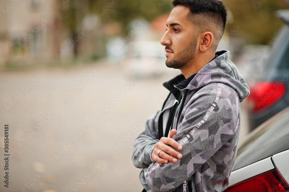 Student kuwaiti man wear at hoodie stand near car. Student kuwaiti man wear at hoodie stand near car.