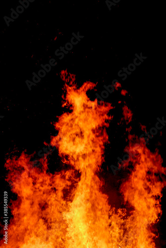 big flames of fire, tongues of fire on black background, blurred motion