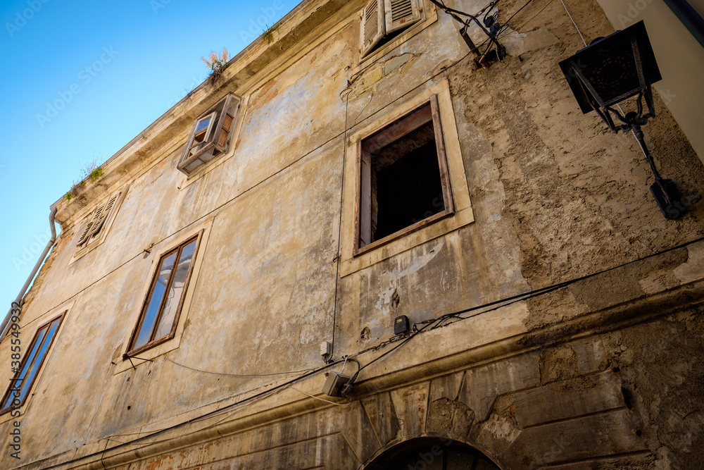 old house in historical city center with open window, italy, tuscany