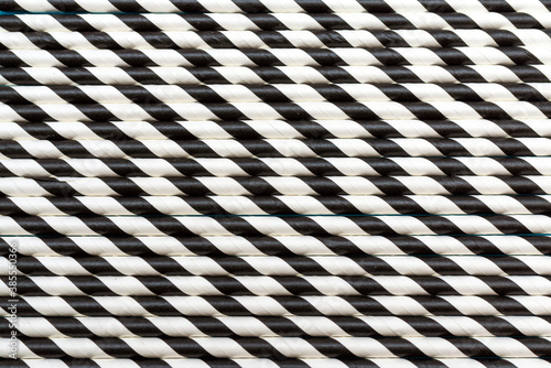 A lot of cocktail striped black and white tubes. Pattern background flat lay.